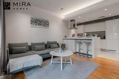 a living room with a couch and a table at Mira Holiday Homes - Serviced 1 bedroom in Bluewaters in Dubai
