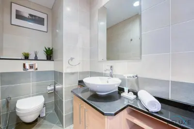 a bathroom with a sink and a toilet at Exquisite 3BR at Ocean Heights Dubai Marina by Deluxe Holiday Homes in Dubai