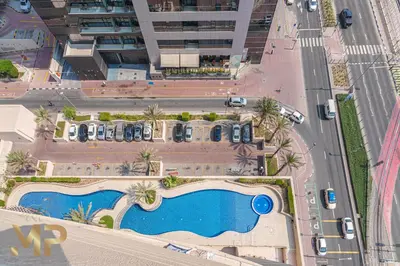 an aerial view of a building with a swimming pool at Marco Polo - Relax in a modern 1BR in Dubai Marina in Dubai