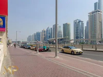 a row of cars parked on the side of a street at Marco Polo - Relax in a modern 1BR in Dubai Marina in Dubai