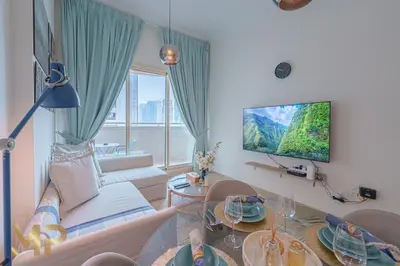a living room with a couch and a table at Marco Polo - Relax in a modern 1BR in Dubai Marina in Dubai