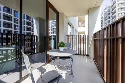 a balcony with a table and chairs in a building at Modern 1 Bedroom Apartment I Creek Beach I Surf in Dubai