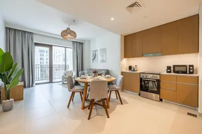 a kitchen and dining room with a table and chairs at Modern 1 Bedroom Apartment I Creek Beach I Surf in Dubai