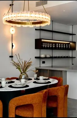 a dining room with a table with chairs and a chandelier at Mira Holiday Homes - Serviced 2 bedroom in Dubai Marina in Dubai