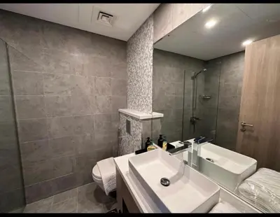 a bathroom with a sink and a shower and a toilet at Mira Holiday Homes - Serviced 2 bedroom in Dubai Marina in Dubai