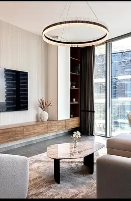 a living room with a coffee table and a chandelier at Mira Holiday Homes - Serviced 2 bedroom in Dubai Marina in Dubai