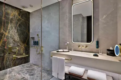 a bathroom with a sink and a shower at Embassy Suites By Hilton Dubai Business Bay in Dubai