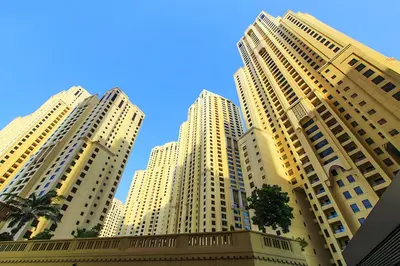 three tall buildings with palm trees in front of them at Amazing 1BR With Sea View Rimal 4 JBR - NOX Holiday Homes in Dubai