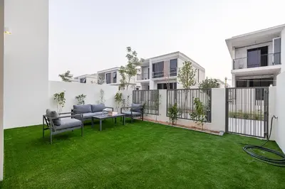 a patio with green grass in a building at Townhouse with Garden I Tilal Al Ghaf I Elan B in Dubai