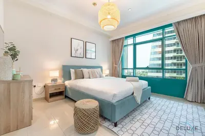 a bedroom with a bed and a large window at Dazzling 1BR at Marina Crown Dubai Marina by Deluxe Holiday Homes in Dubai