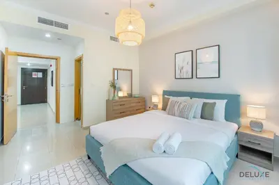 a bedroom with a large bed with two white towels on it at Dazzling 1BR at Marina Crown Dubai Marina by Deluxe Holiday Homes in Dubai