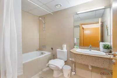 a bathroom with a tub and a toilet and a sink at Dazzling 1BR at Marina Crown Dubai Marina by Deluxe Holiday Homes in Dubai