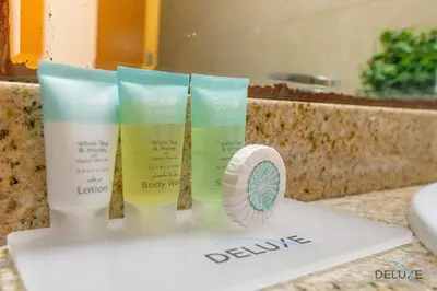 a group of four products sitting on a bathroom counter at Dazzling 1BR at Marina Crown Dubai Marina by Deluxe Holiday Homes in Dubai