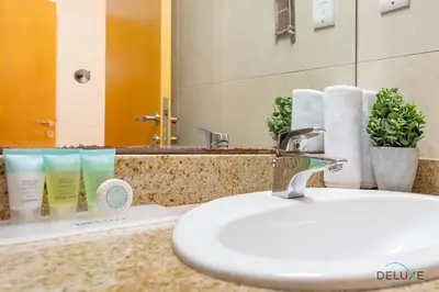 a bathroom counter with a sink and a mirror at Dazzling 1BR at Marina Crown Dubai Marina by Deluxe Holiday Homes in Dubai