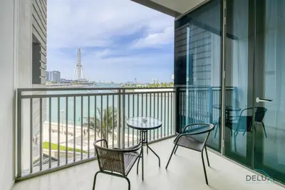 a balcony with a table and chairs and a view of the ocean at Sleek 1BR at 5242 Tower 1 Dubai Marina by Deluxe Holiday Homes in Dubai