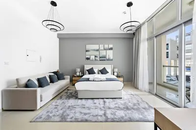 a bedroom with a bed and a couch at StoneTree - Cozy Studio in DEC Tower - Dubai Marina in Dubai