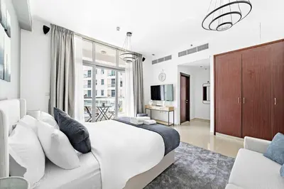 a bedroom with a large bed and a large window at StoneTree - Cozy Studio in DEC Tower - Dubai Marina in Dubai