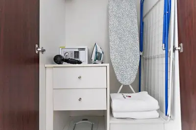 a bathroom with a white dresser with a microwave at StoneTree - Cozy Studio in DEC Tower - Dubai Marina in Dubai