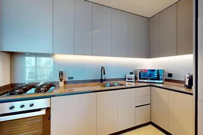 a kitchen with white cabinets and a sink at 15 Northside A - Pristine Two Bedroom in Dubai