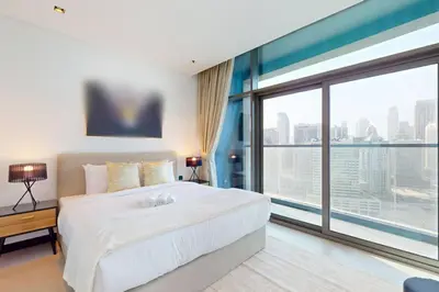 a bedroom with a large bed and a large window at 15 Northside A - Pristine Two Bedroom in Dubai