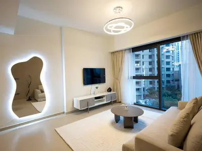 a living room with a couch and a tv at MH - Act One Act Two - DownTown - 1BHK - REF505 in Dubai