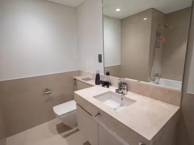 a bathroom with a sink and a toilet and a mirror at MH - Act One Act Two - DownTown - 1BHK - REF505 in Dubai