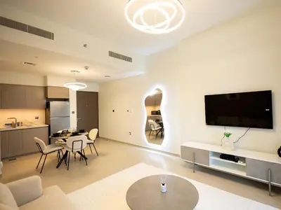 a living room with a kitchen and a dining room at MH - Act One Act Two - DownTown - 1BHK - REF505 in Dubai