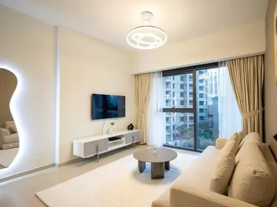 a living room with a couch and a tv at MH - Act One Act Two - DownTown - 1BHK - REF505 in Dubai