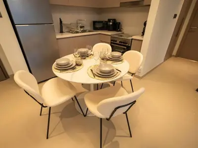 a white table and chairs in a kitchen at MH - ACT TOWER - Downtown -1Bedroom Apartment - REF504 in Dubai