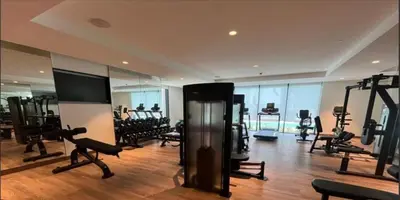 a gym with a lot of treadmills and machines at MH - ACT TOWER - Downtown -1Bedroom Apartment - REF504 in Dubai