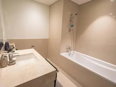 a bathroom with a tub and a sink and a bath tub at MH - ACT TOWER - Downtown -1Bedroom Apartment - REF504 in Dubai