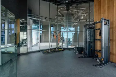 an empty room with a gym with glass walls at GuestReady - Majestic canal and Burj Khalifa view in Dubai