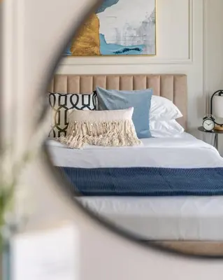 a bedroom with a bed with blue and white pillows at GuestReady - Modernity elegance in Dubai Marina in Dubai