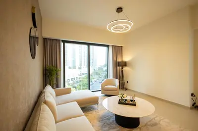 a living room with a couch and a table at MH - ACT Tower -Downtown- 2Bedrooms - REF 408 in Dubai