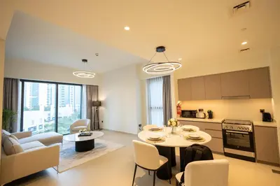 a kitchen and living room with a table and chairs at MH - ACT Tower -Downtown- 2Bedrooms - REF 408 in Dubai