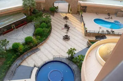 an overhead view of a swimming pool in a mall at Your Silicon Oasis Escape-1BHK in Dubai