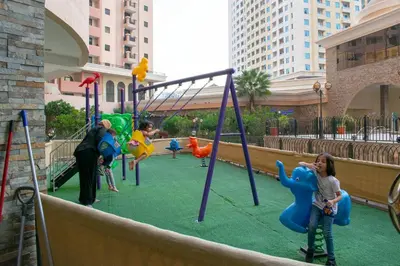 a group of children playing on a playground at Your Silicon Oasis Escape-1BHK in Dubai