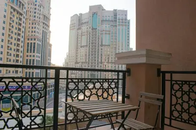 a bench on a balcony with a view of a city at Your Silicon Oasis Escape-1BHK in Dubai