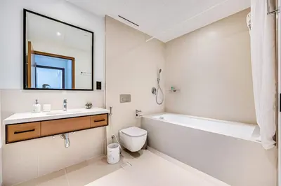 a bathroom with a sink and a tub and a toilet at Elegant 3BD family home in Marina Vida Residence in Dubai