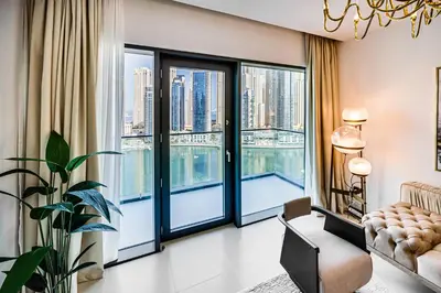 a living room with large windows and a chandelier at Elegant 3BD family home in Marina Vida Residence in Dubai