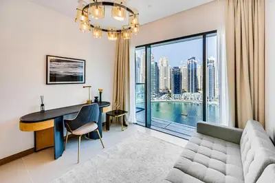 a living room with a couch and a table and a desk at Elegant 3BD family home in Marina Vida Residence in Dubai