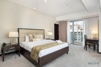 a large bedroom with a large bed and a desk at Marina Canal Views 2BR Unit Next to Marina Mall, The Address Residences, Dubai Marina by Deluxe Holiday Homes in Dubai