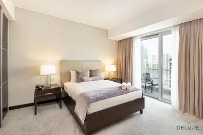 a bedroom with a bed and a large window at Marina Canal Views 2BR Unit Next to Marina Mall, The Address Residences, Dubai Marina by Deluxe Holiday Homes in Dubai