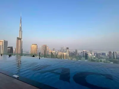 a swimming pool on top of a building with a city at Unique 2br with Infinity Pool view on Burj Khalifa in Dubai