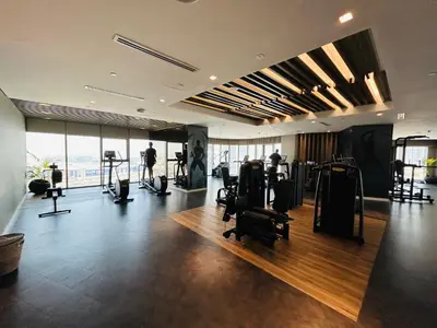 a gym with treadmills and exercise equipment in a building at Unique 2br with Infinity Pool view on Burj Khalifa in Dubai