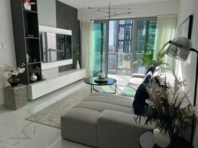 a living room with a couch and a table at 8 Boulevard Walk 'Heart of Downtown' in Dubai