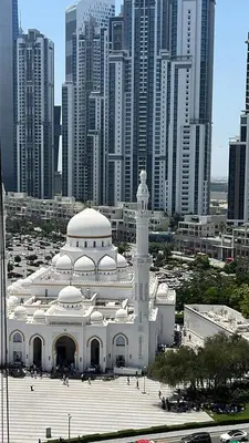 a large white building in front of a city at 8 Boulevard Walk 'Heart of Downtown' in Dubai