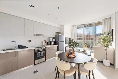 a kitchen with a table and chairs in a room at Silkhaus awesome 1BDR in Opera District in Dubai