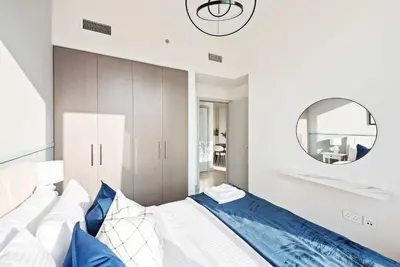 a bedroom with a bed and a mirror at Silkhaus awesome 1BDR in Opera District in Dubai