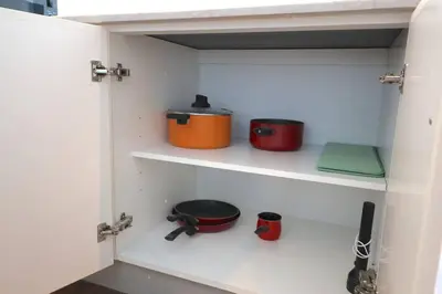 a pantry with two pots and pans on shelves at Deluxe - Amazing views - Elite in Dubai